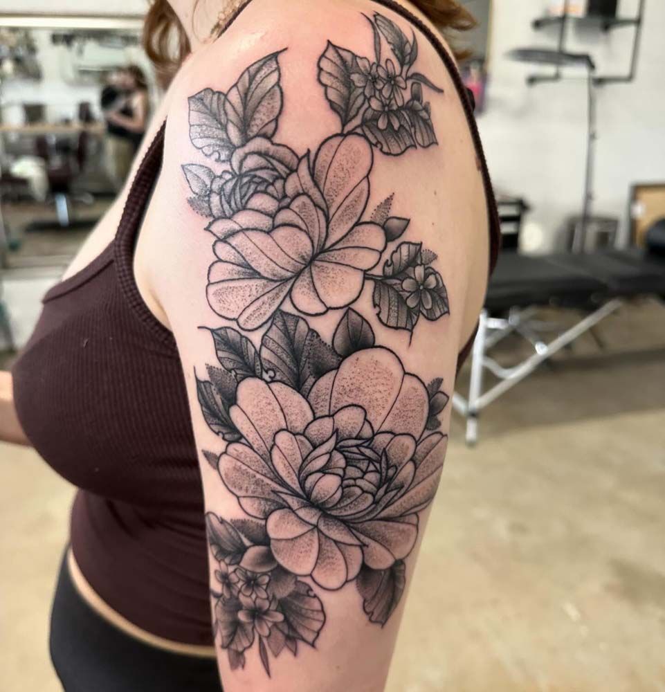 A woman has a tattoo of flowers on her arm