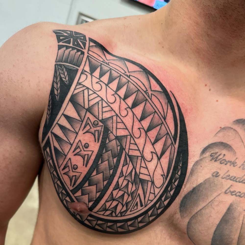 A man has a black and white tattoo on his chest