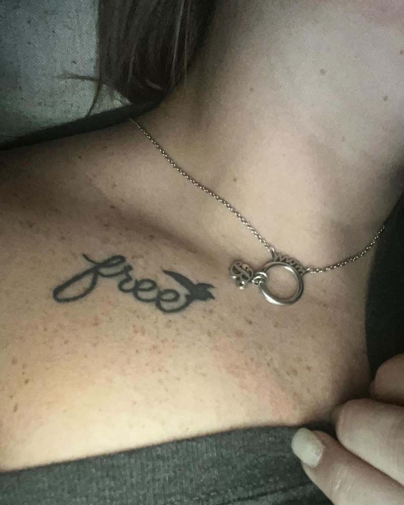 A woman has a tattoo of the word free on her chest.