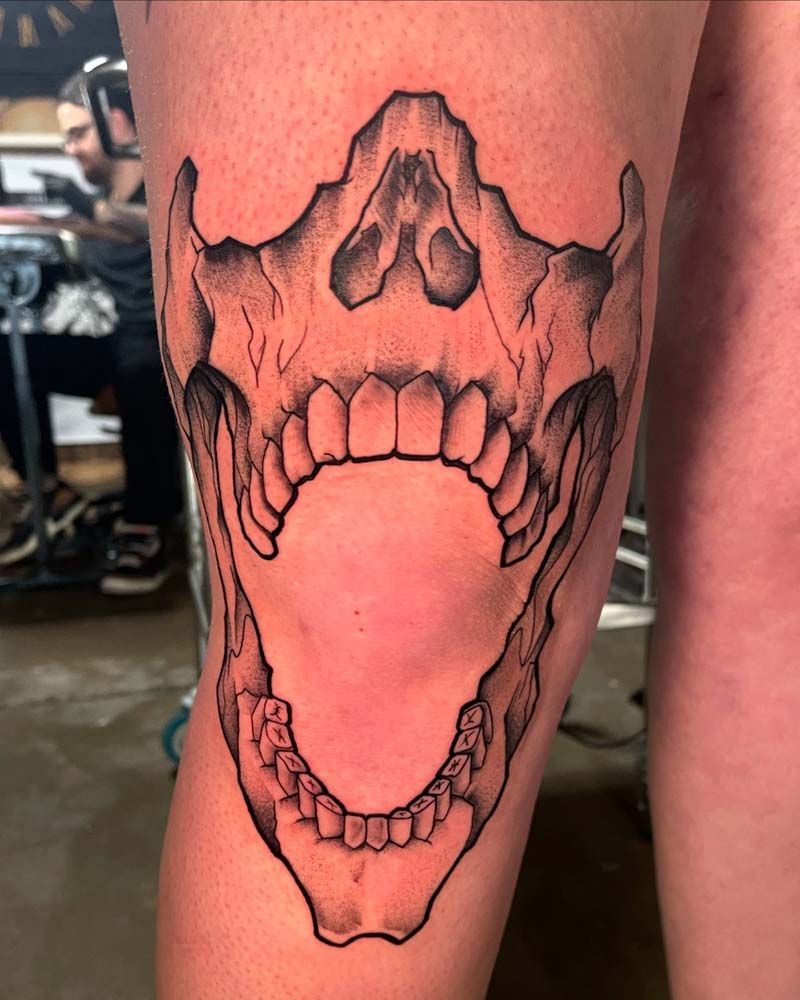 A person has a tattoo of a skull on their leg