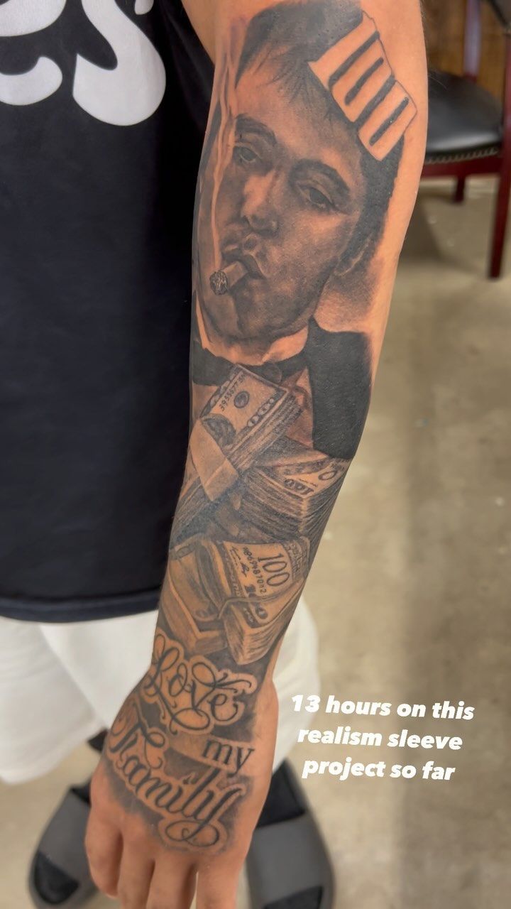 A man has a tattoo of a man holding money on his arm