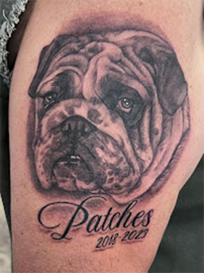 A tattoo of a bulldog with the name patches on it