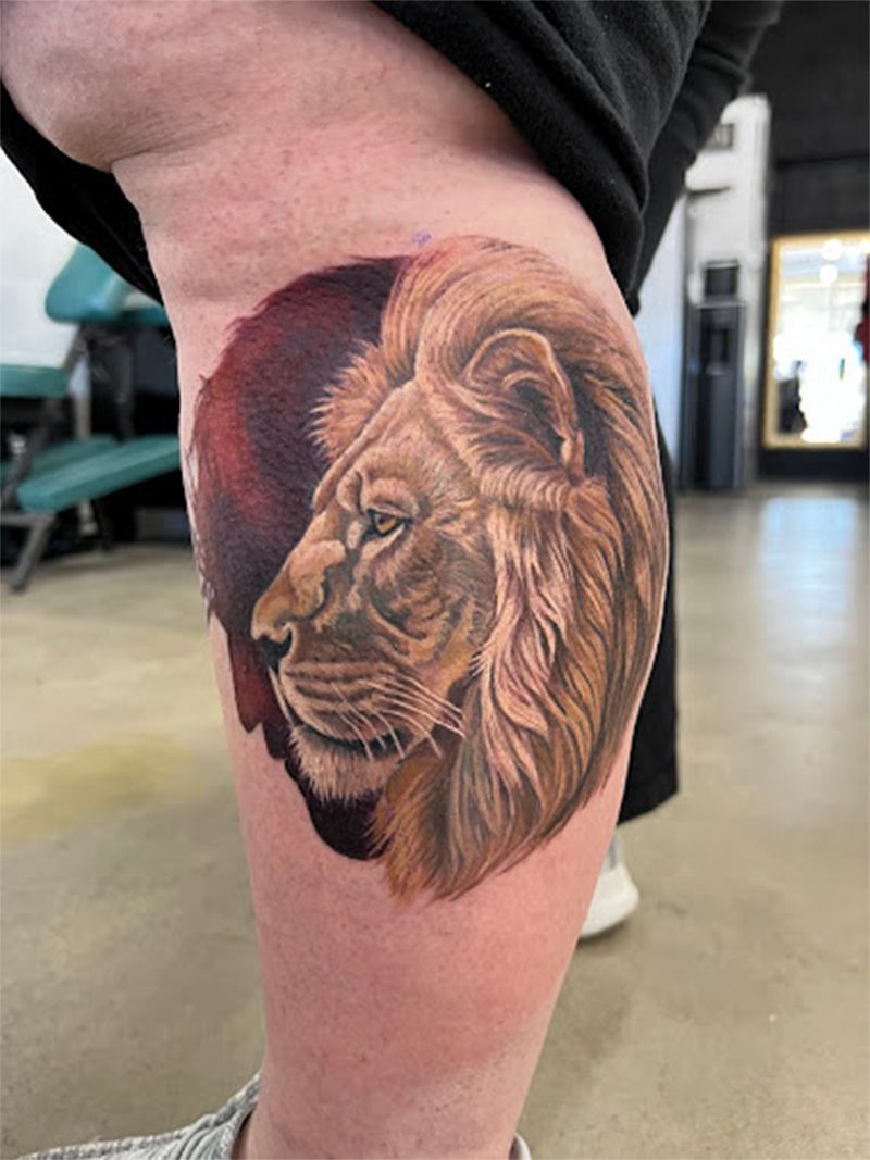 A person has a tattoo of a lion on their leg.