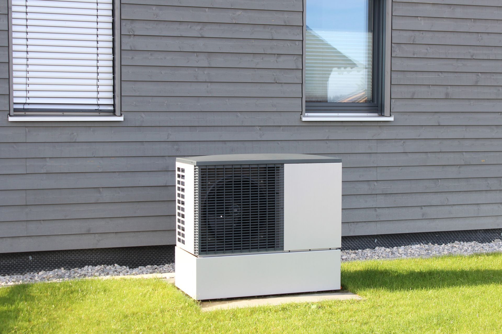 Houston Admiral installed a modern heat pump unit outside a residential home during summer.