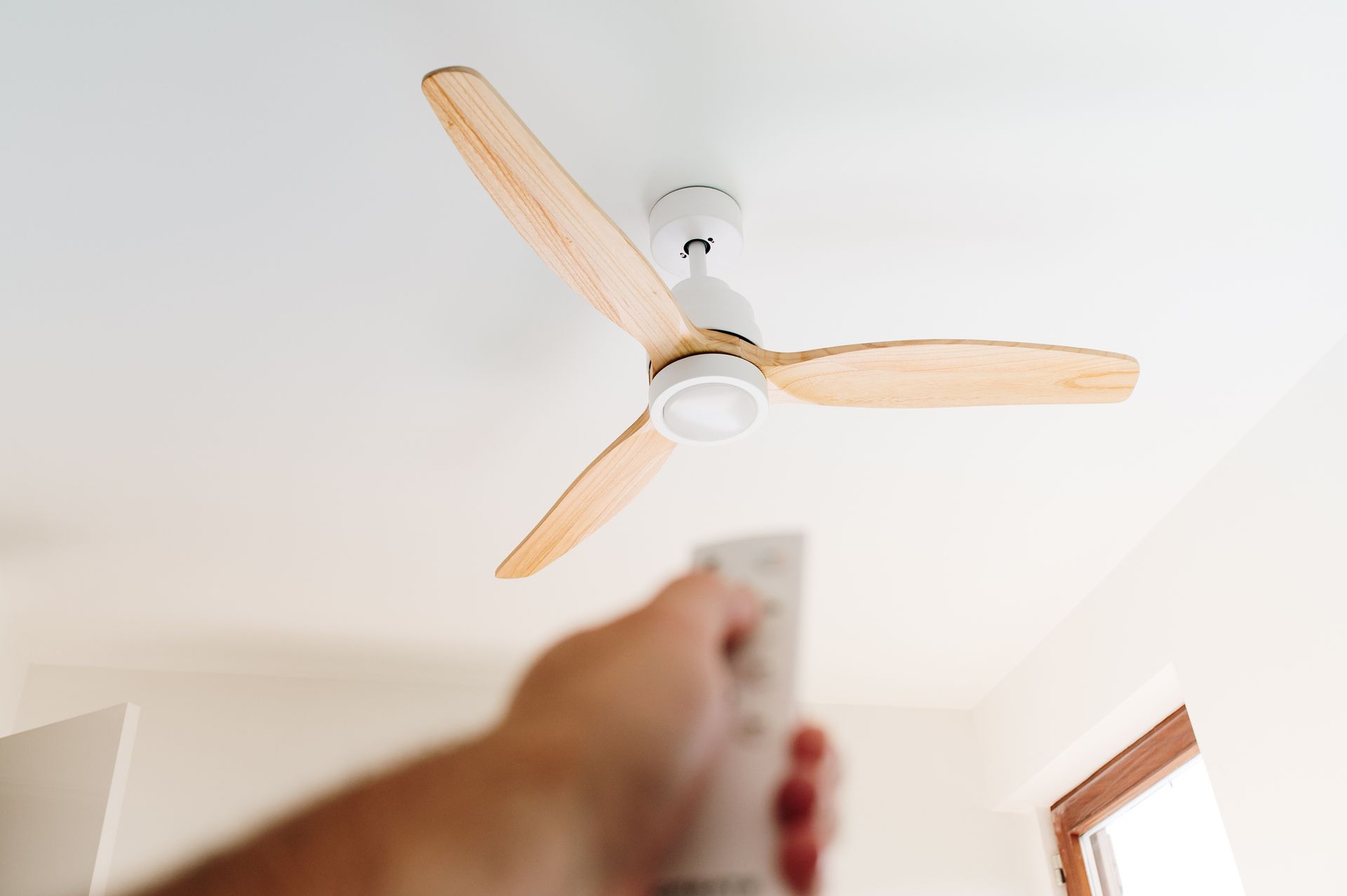 Ceiling fan spinning in a bright living room during summer in Magnolia, Texas.