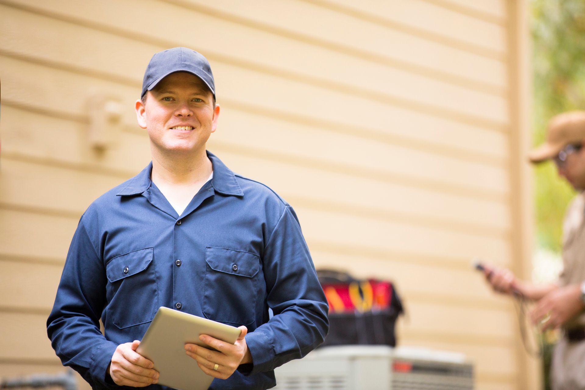Houston Admiral HVAC technician inspecting an outdoor air conditioning unit at a Houston home.