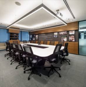 A conference room of a commercial office with a long table and chairs.