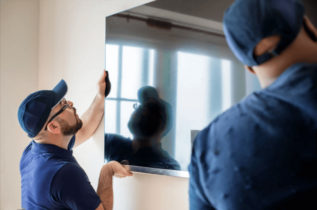 Technicians hanging a TV
