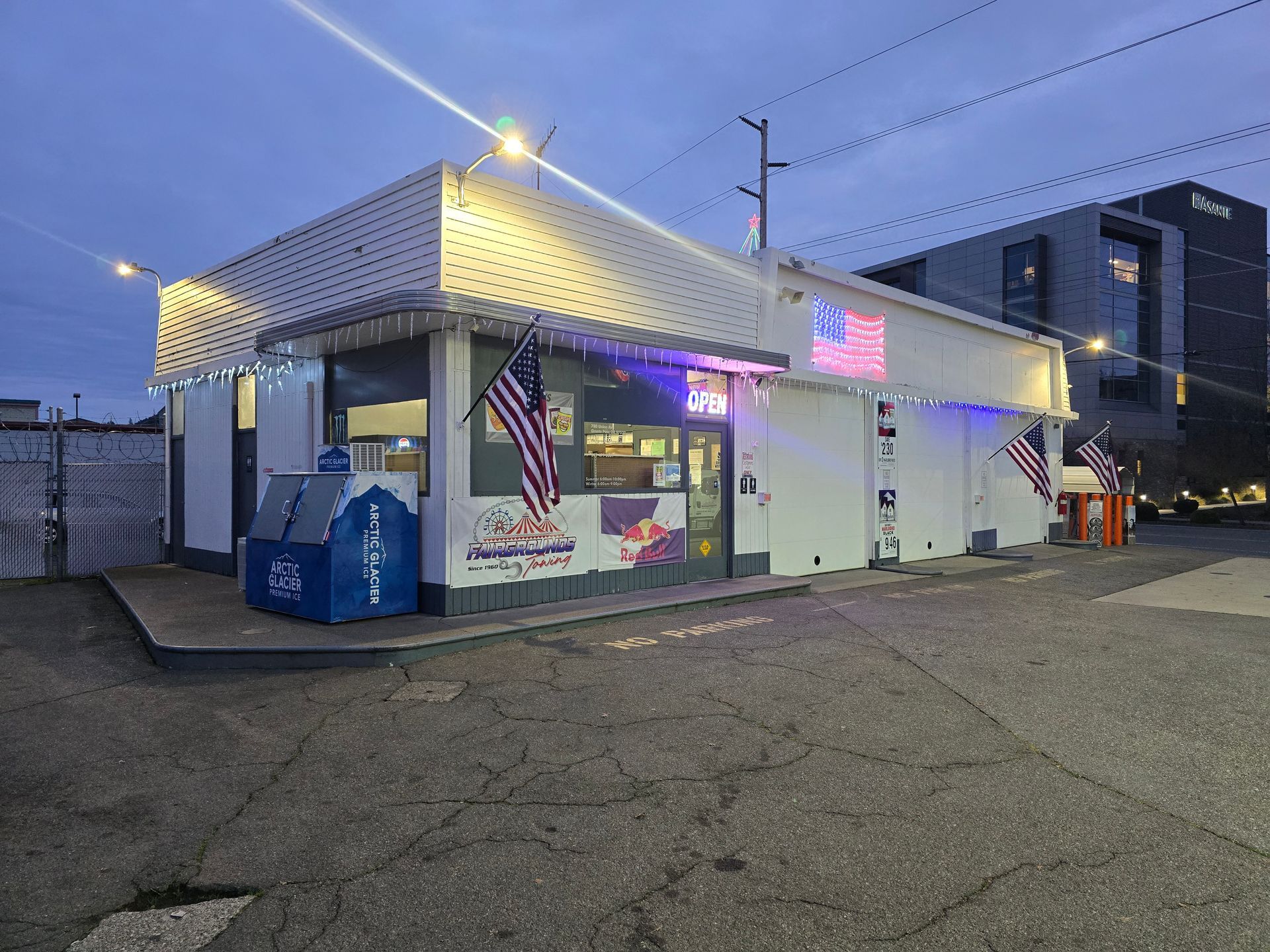 Modern roadside gas station services with red canopy and fuel pumps under blue sky. Modern roadside gas station services with red canopy and fuel pumps under blue sky.