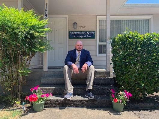 Dennis Cygan sitting outside the front of the office