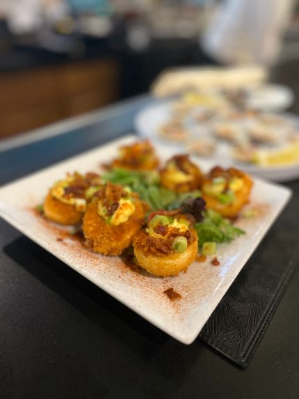 Plate of seafood ceviche with red onion and Pacifico beer can.