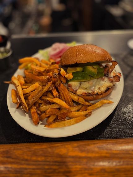 Bread, meats, and preserves on a wooden board, ready for serving.