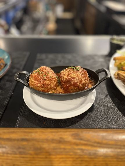 Pasta dish with mussels and clams in a white bowl.