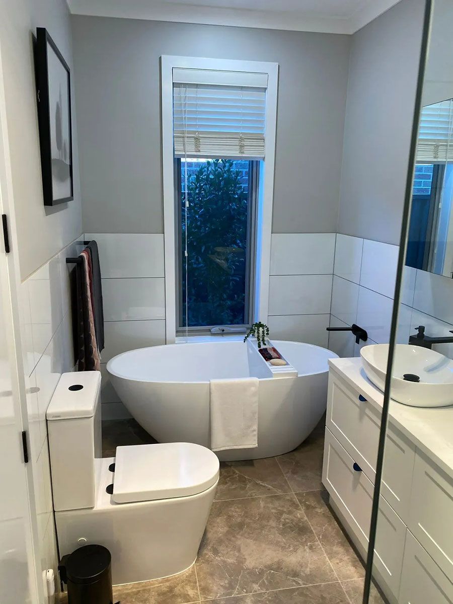 A Bathroom With A Tub , Toilet , Sink And Mirror — Ultimate Bathrooms Ballarat In Alfredton, VIC