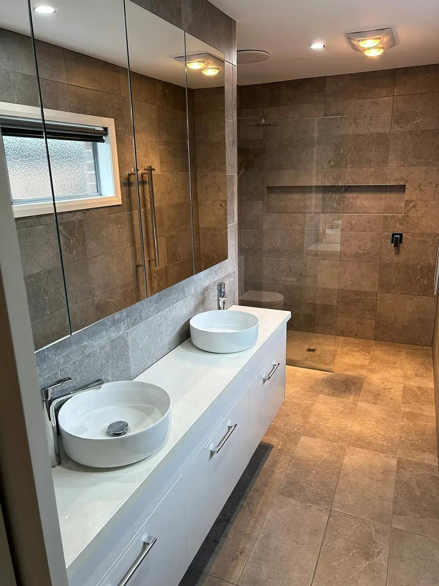 A Bathroom With Two Sinks And A Walk In Shower — Ultimate Bathrooms Ballarat In Alfredton, VIC