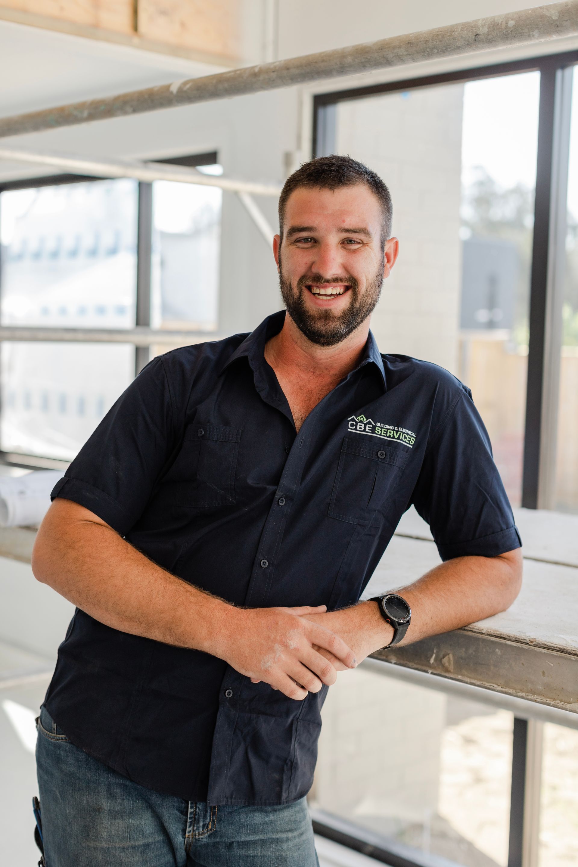 A man with a beard is standing in front of a window — Custom Home Builders in the Hunter Valley