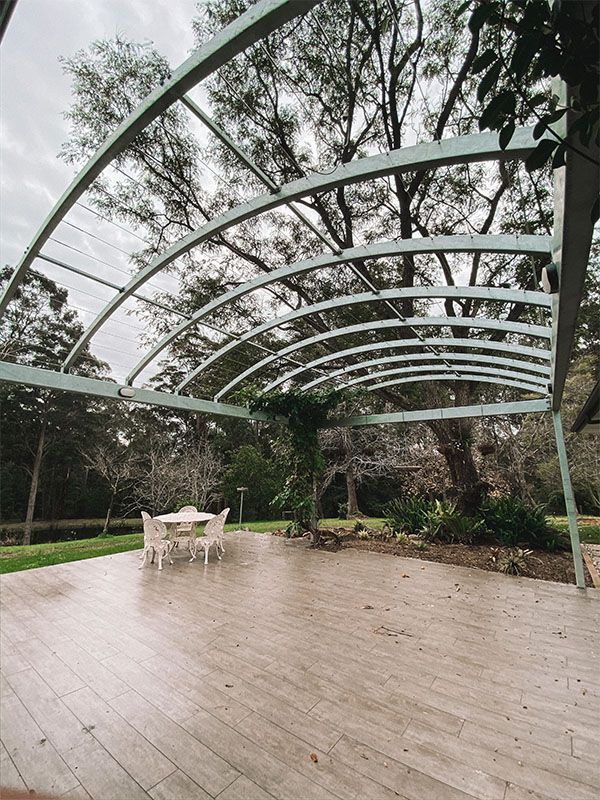 Large Outdoor Entertaining Area With Curved Sun Roof — Custom Home Builders in the Hunter Valley