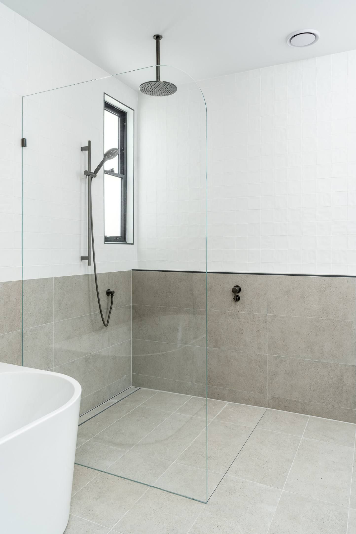 A bathroom with a walk in shower and a bathtub — Custom Home Builders in the Hunter Valley