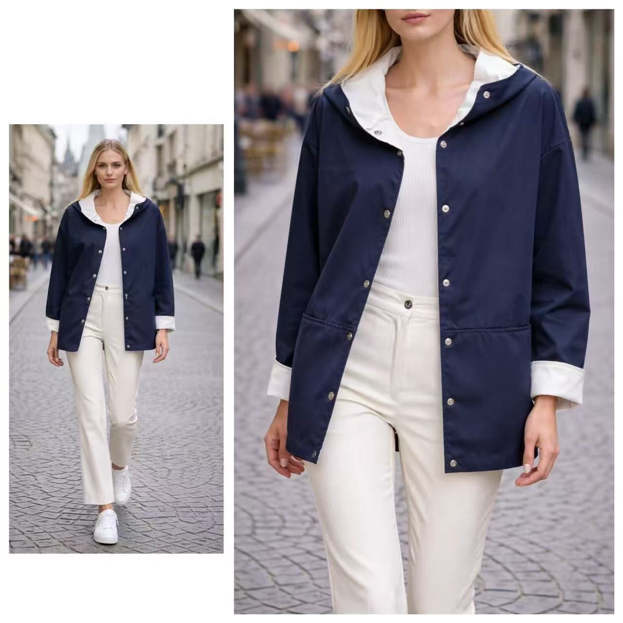Una modella indossa un impermeabile con cappuccio blu scuro sopra una maglietta e pantaloni bianchi, mentre cammina lungo una strada lastricata in pietra.