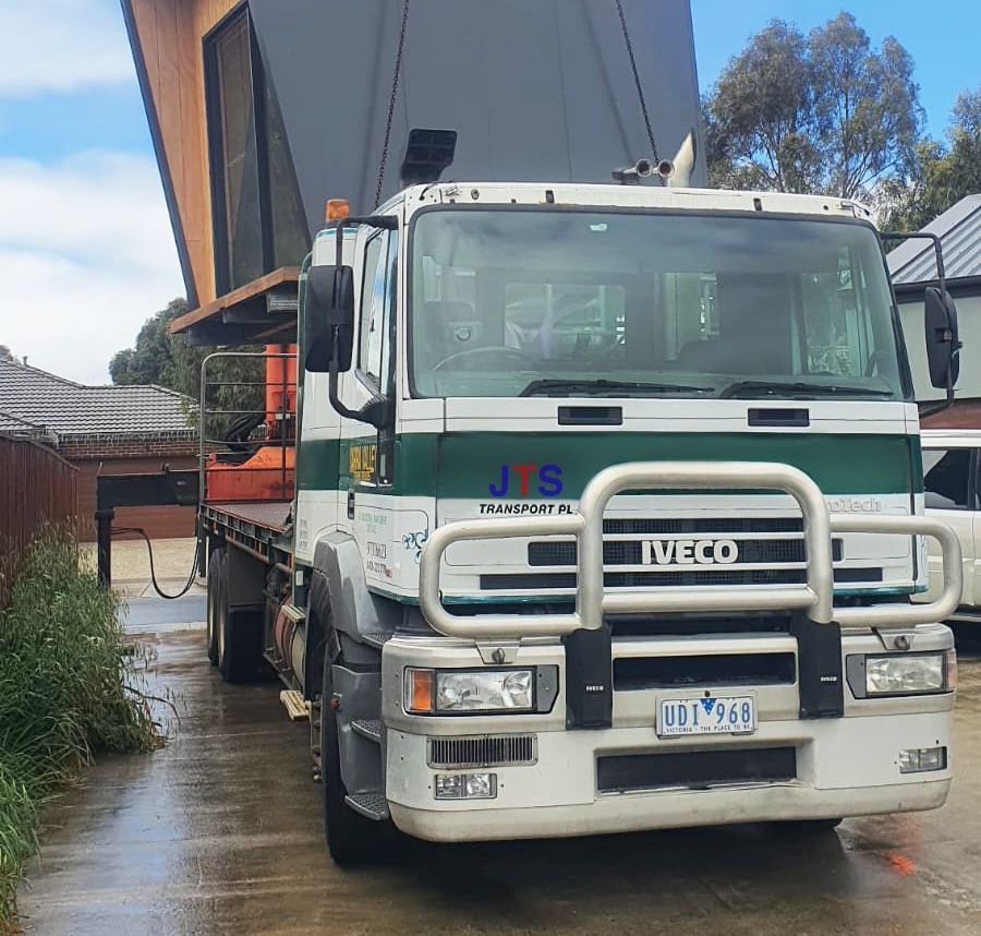 An image of row of trucks and an image of a crane.