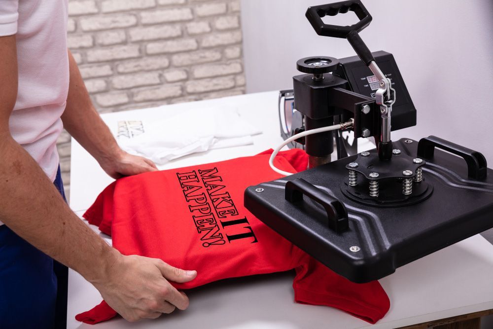 Person is Pressing a Red Shirt on a Machine — Uniforms2U in Blacktown, NSW