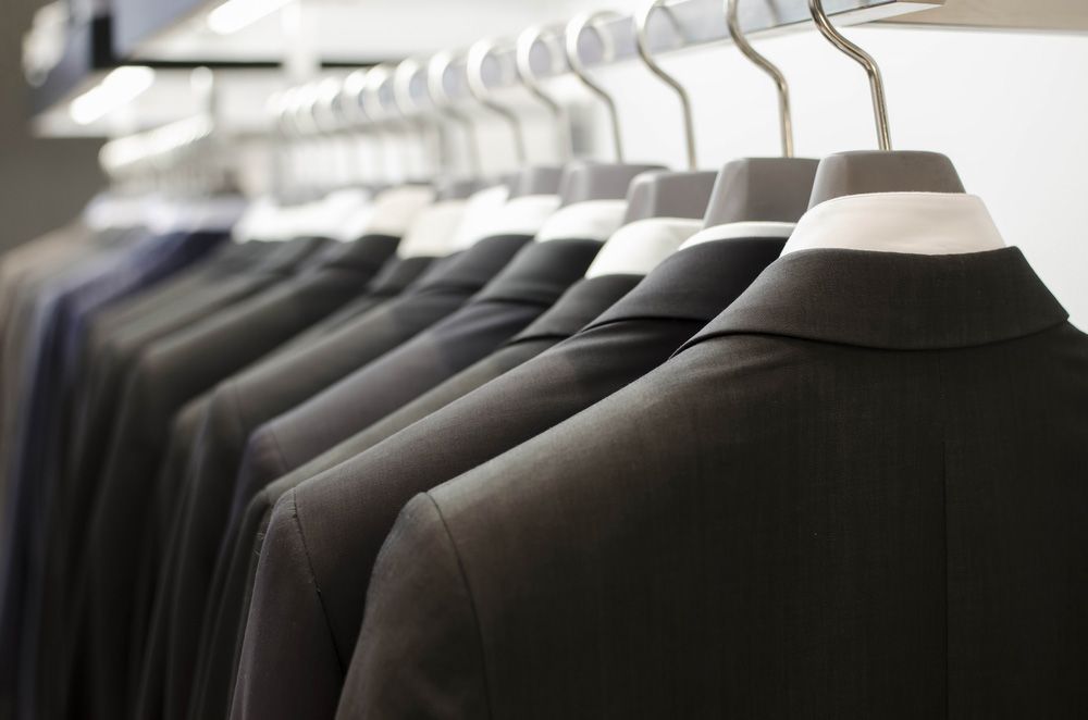 Suits Hanging on a Rack in a Store — Uniforms2U in Campbelltown, NSW