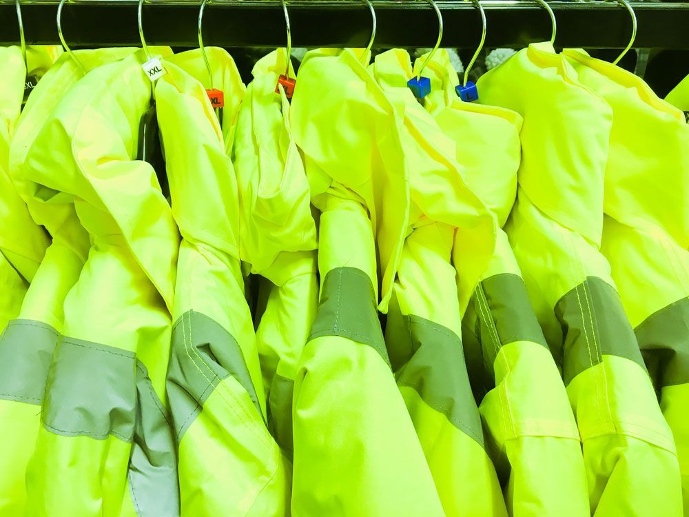 Neon Yellow Jackets Hanging on a Rack — Uniforms2U in Penrith, NSW