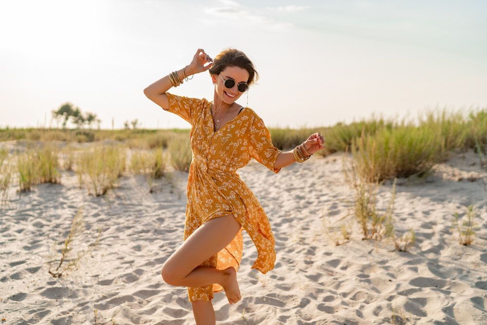 Woman in Yellow Dress Dancing on the Beach — Uniforms2U in Blacktown, NSW