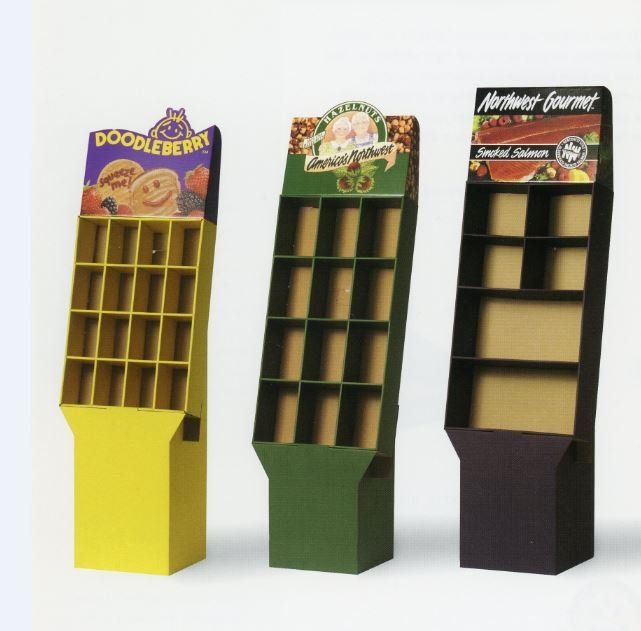 Three cardboard display stands with product labels: yellow, green, and black.