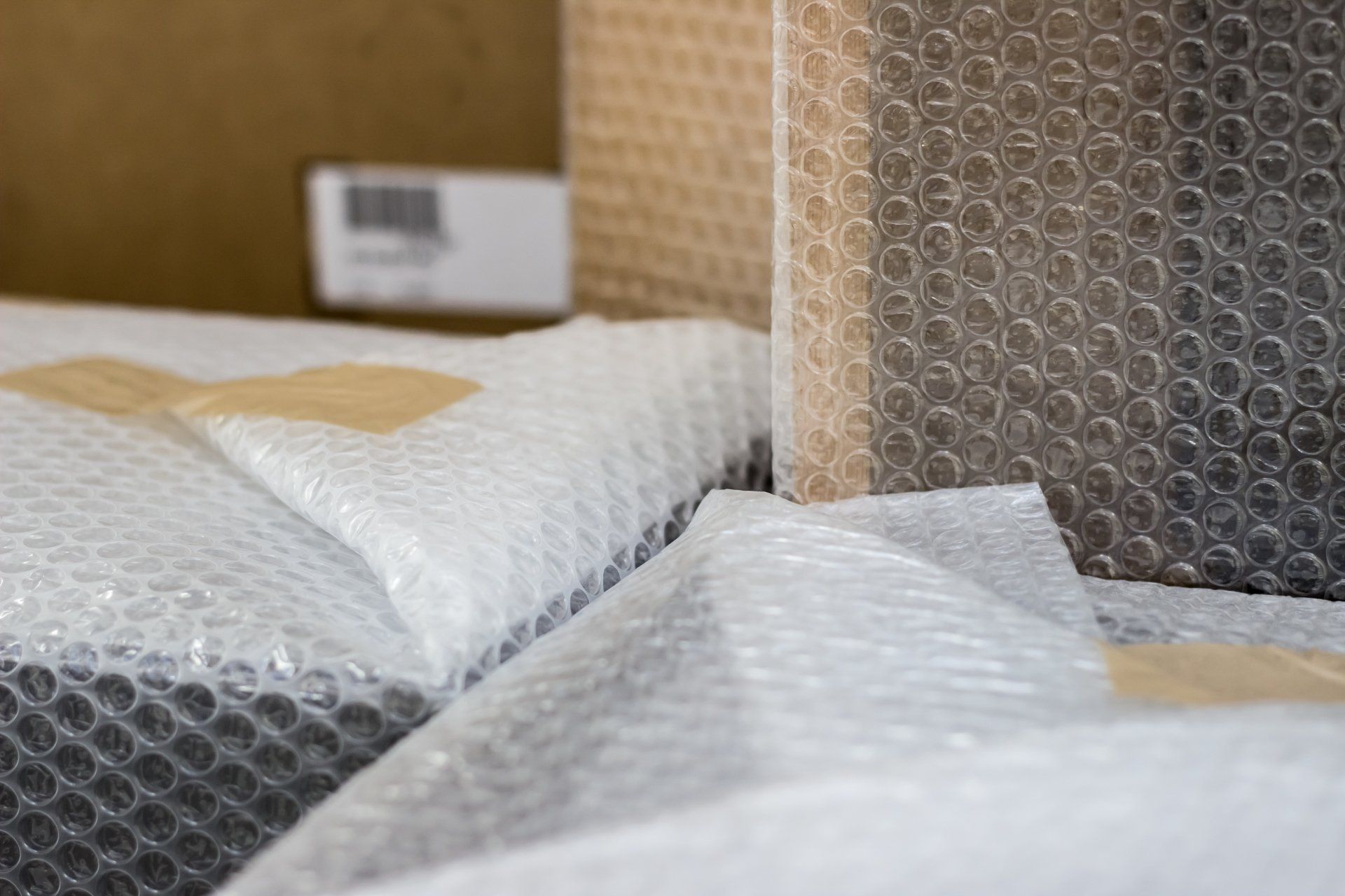 Boxes wrapped in bubble wrap, ready for shipping.