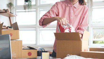 Custom Packaging — Lady Placing Shoe on Box in Portland, OR