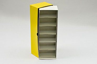 Yellow and white narrow shelf unit with several shelves, on a white surface.