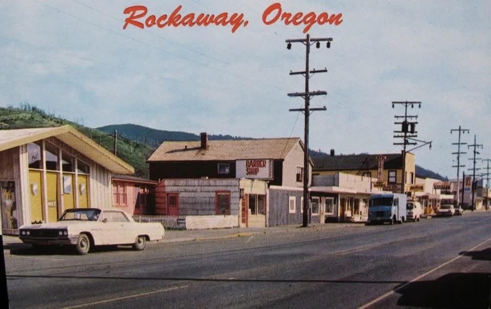 Rockaway, Oregon, street scene with vintage buildings, utility poles, and a white car.