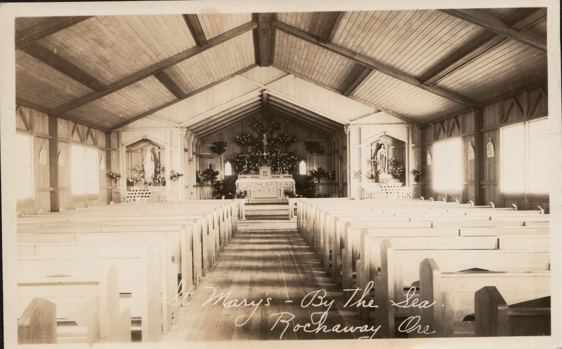Interior of a church, in Rockaway, Oregon. Wooden pews face the altar.