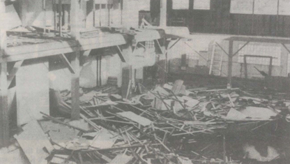 Debris-filled interior. Wood and structure pieces scattered.