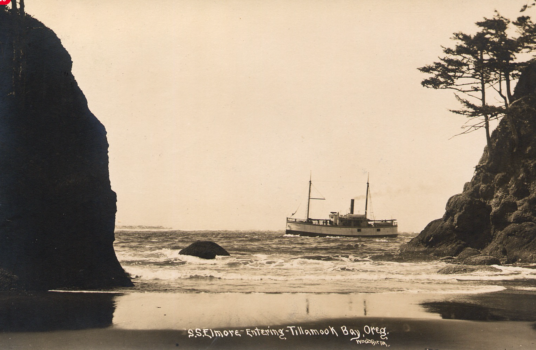 A sepia-toned vintage photo of a steamship passing between two rocky coastal cliffs at the edge of a sandy beach.