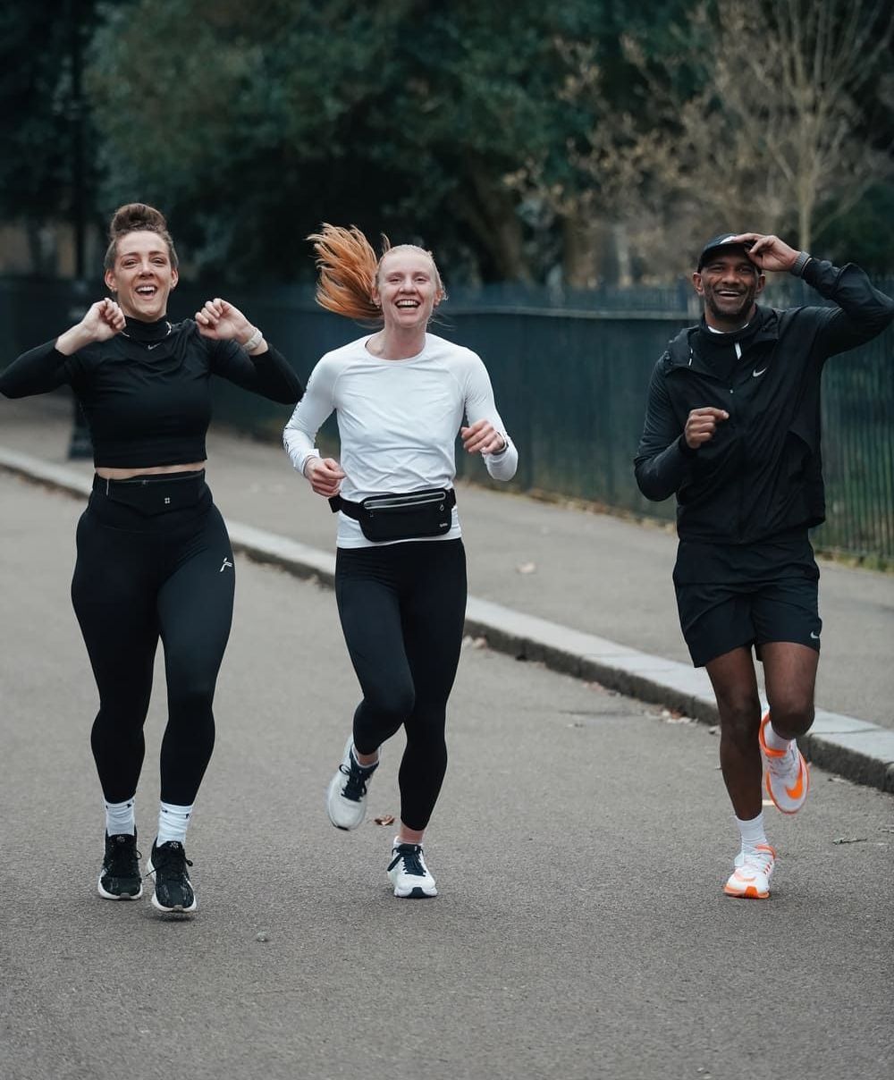 Anil Toraty running together with two women, all smiling