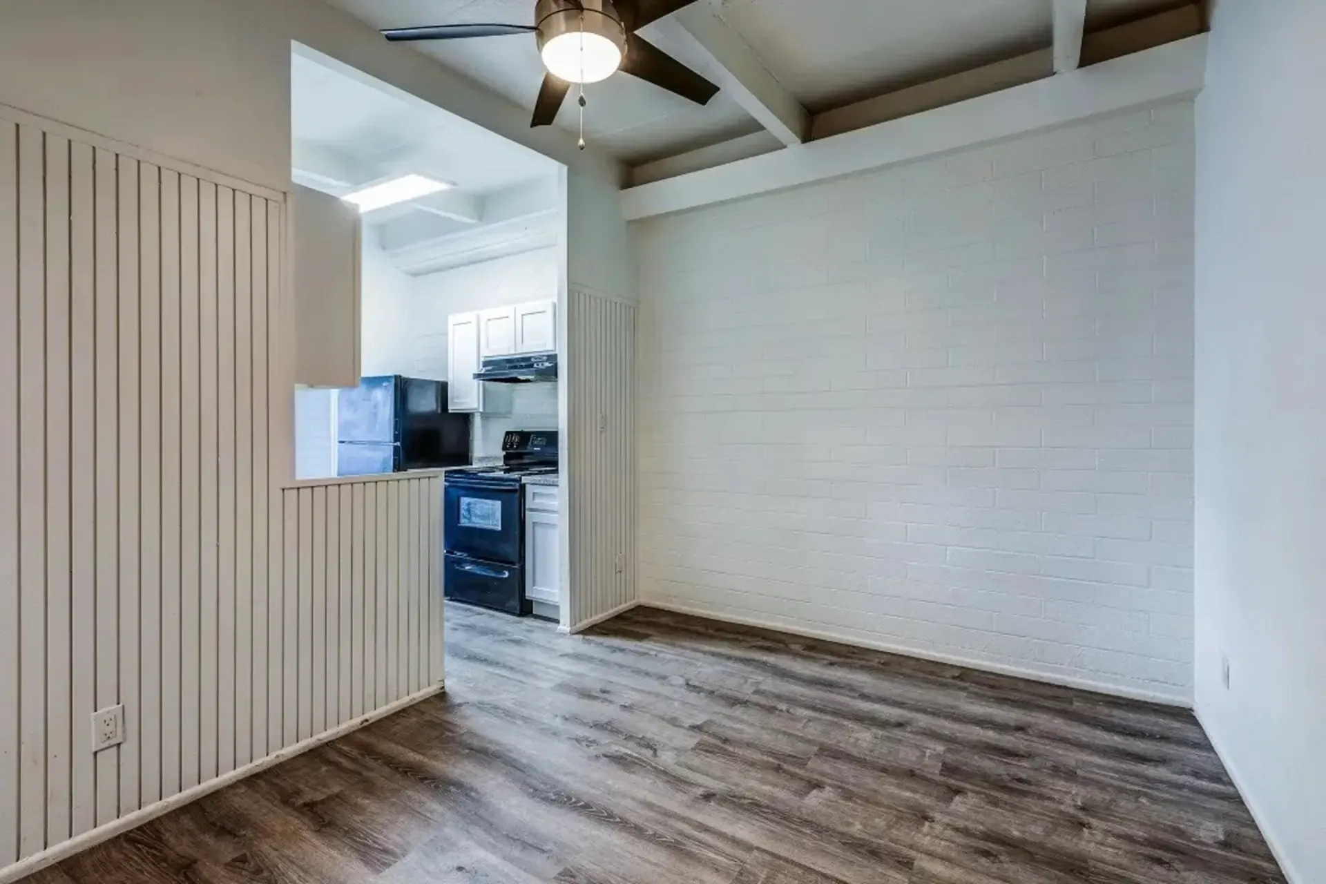 a kitchen with a ceiling fan and a refrigerator