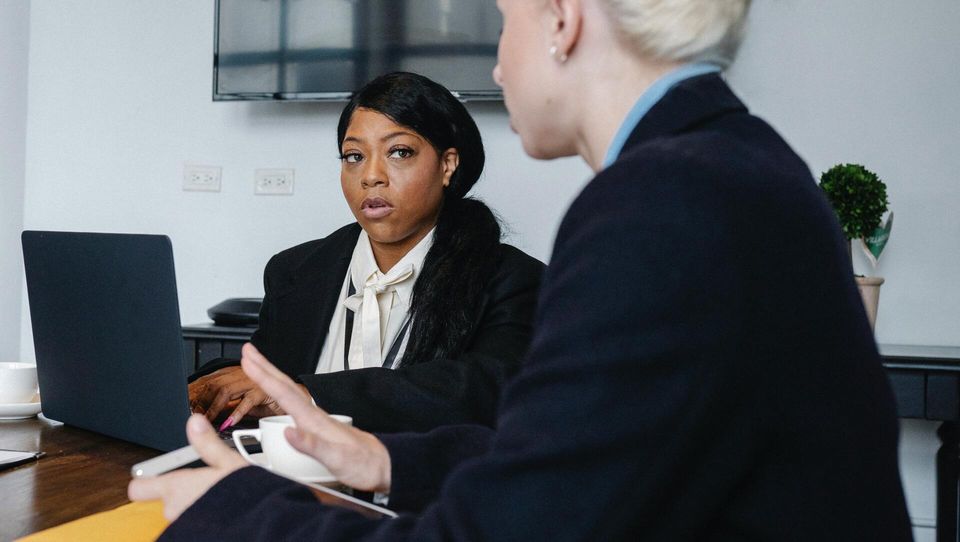 Two women discussing work