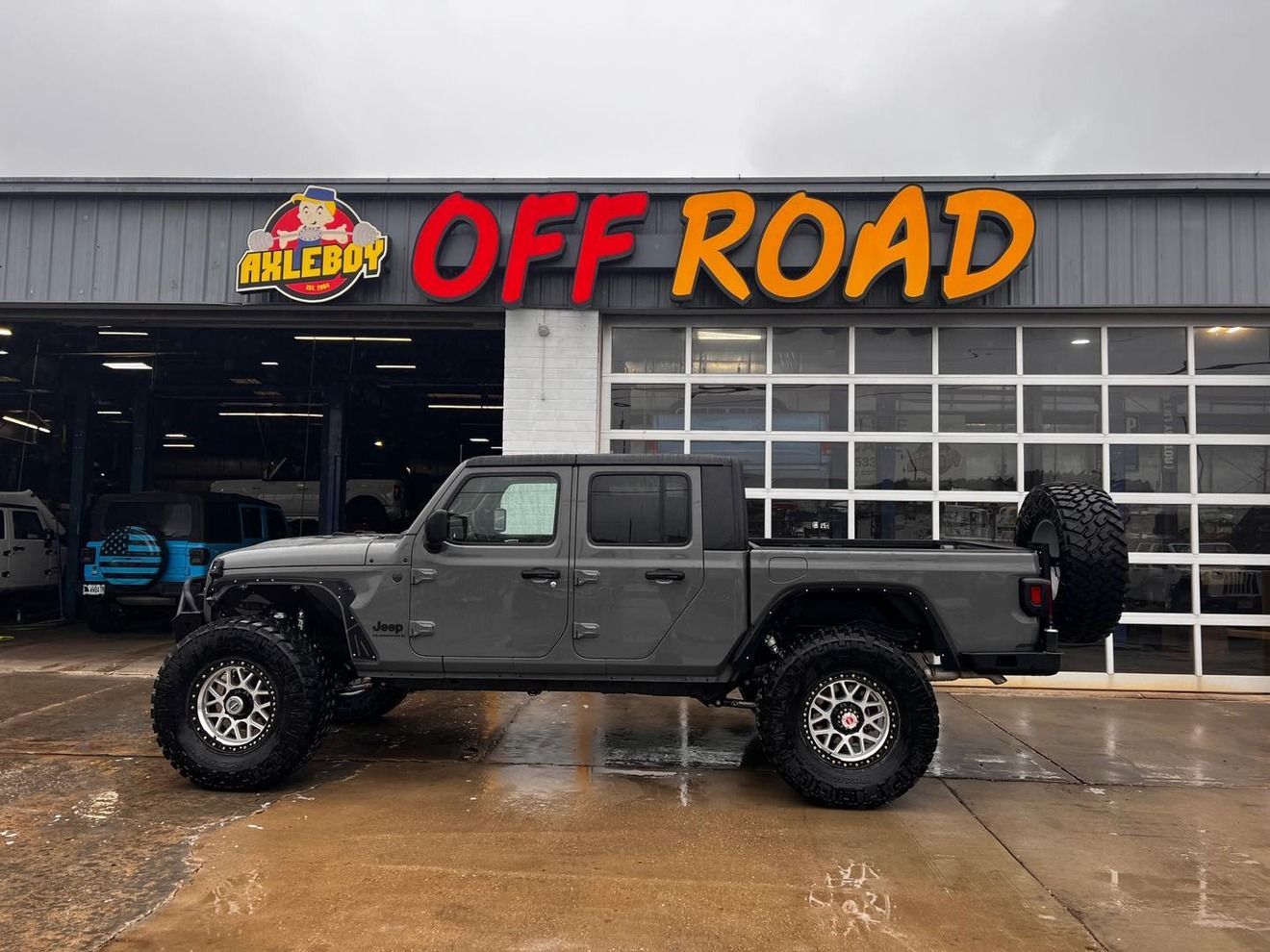Gray Jeep Gladiator truck in front of an 
