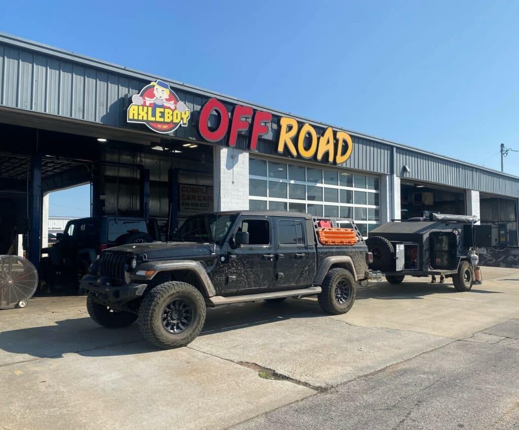 Black Jeep Gladiator with trailer in front of