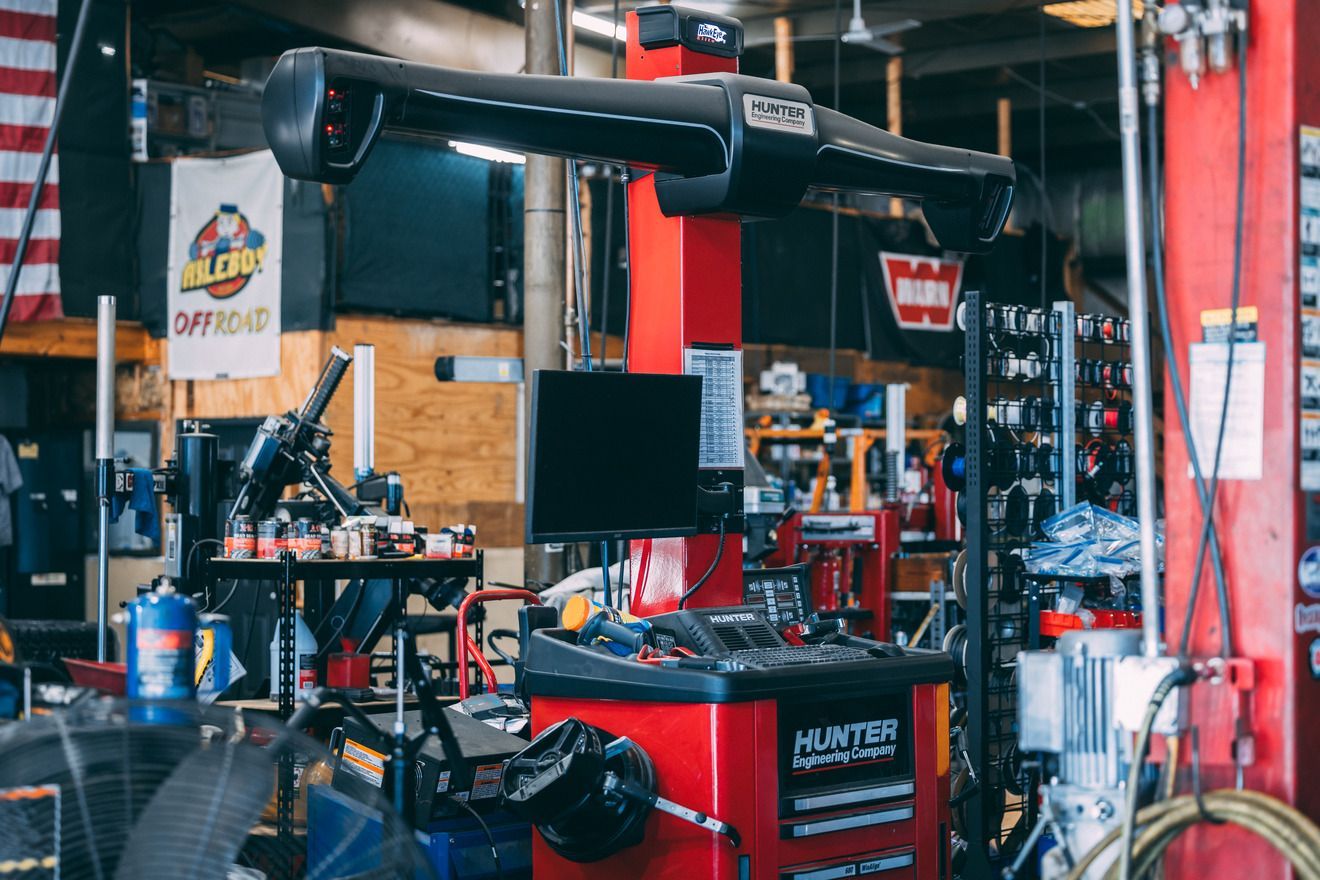 Red Hunter wheel alignment machine in a mechanic shop.