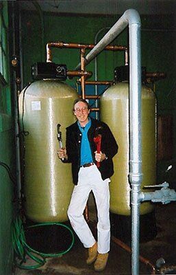 Worker near water filter - Water Consultants in Vineyard Haven, MA