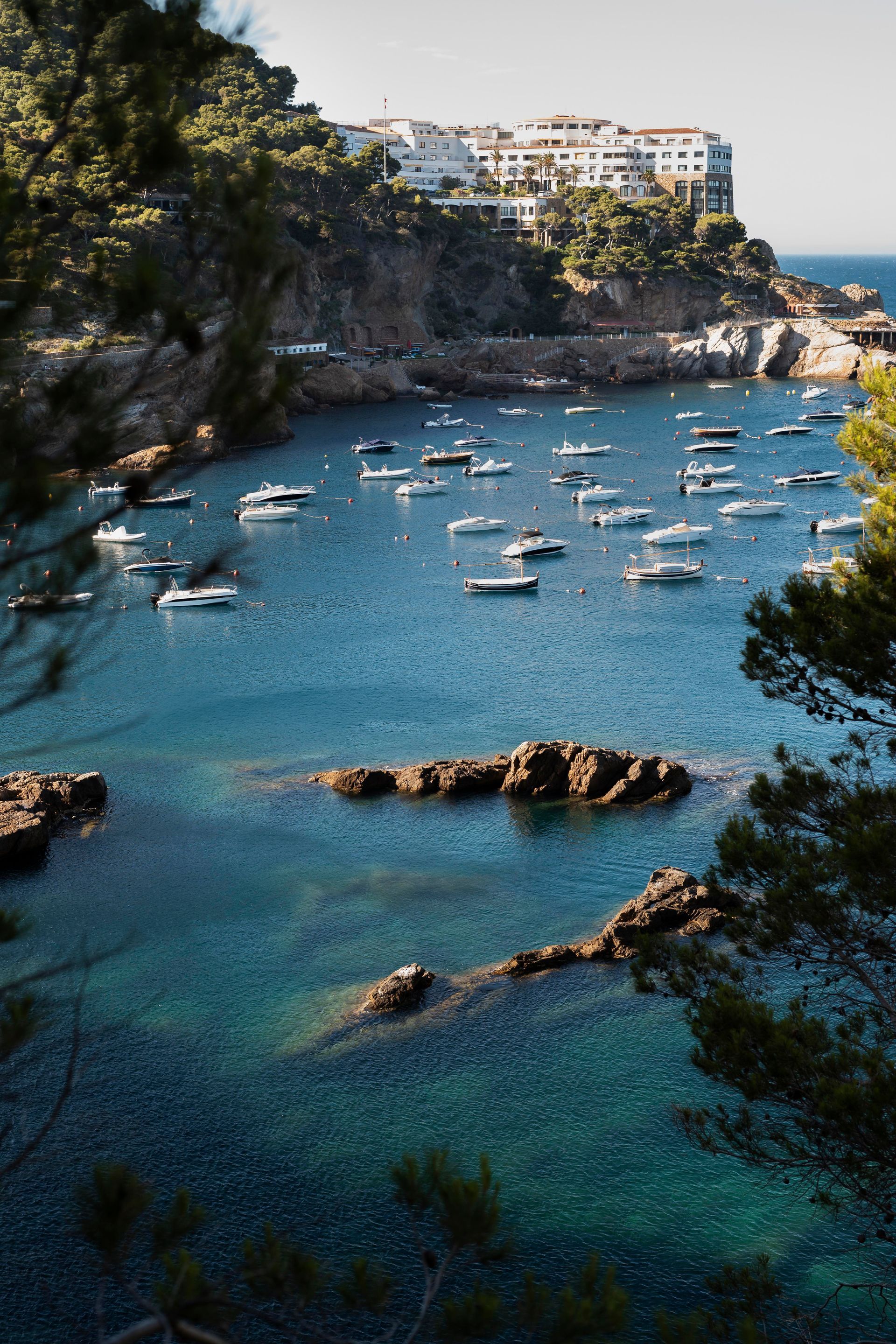 A group of boats are floating on top of a body of water.
