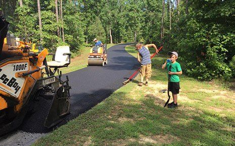 Men Adding Asphalt On Road — Richmond, VA — Absolute Asphalt