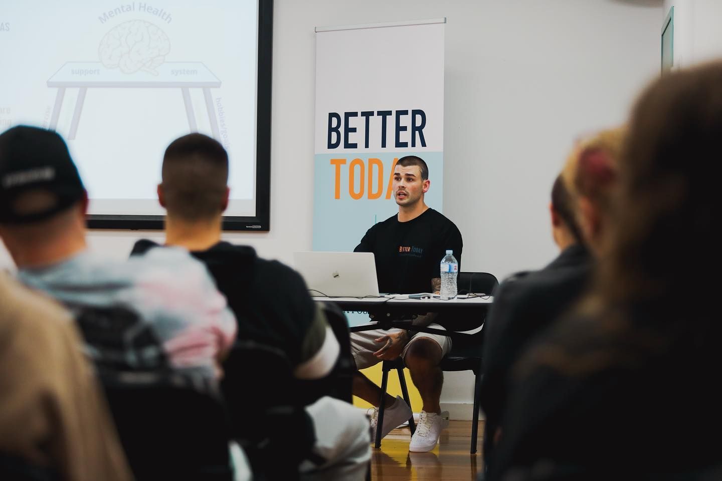 Person in front of room leading workshop while group watches