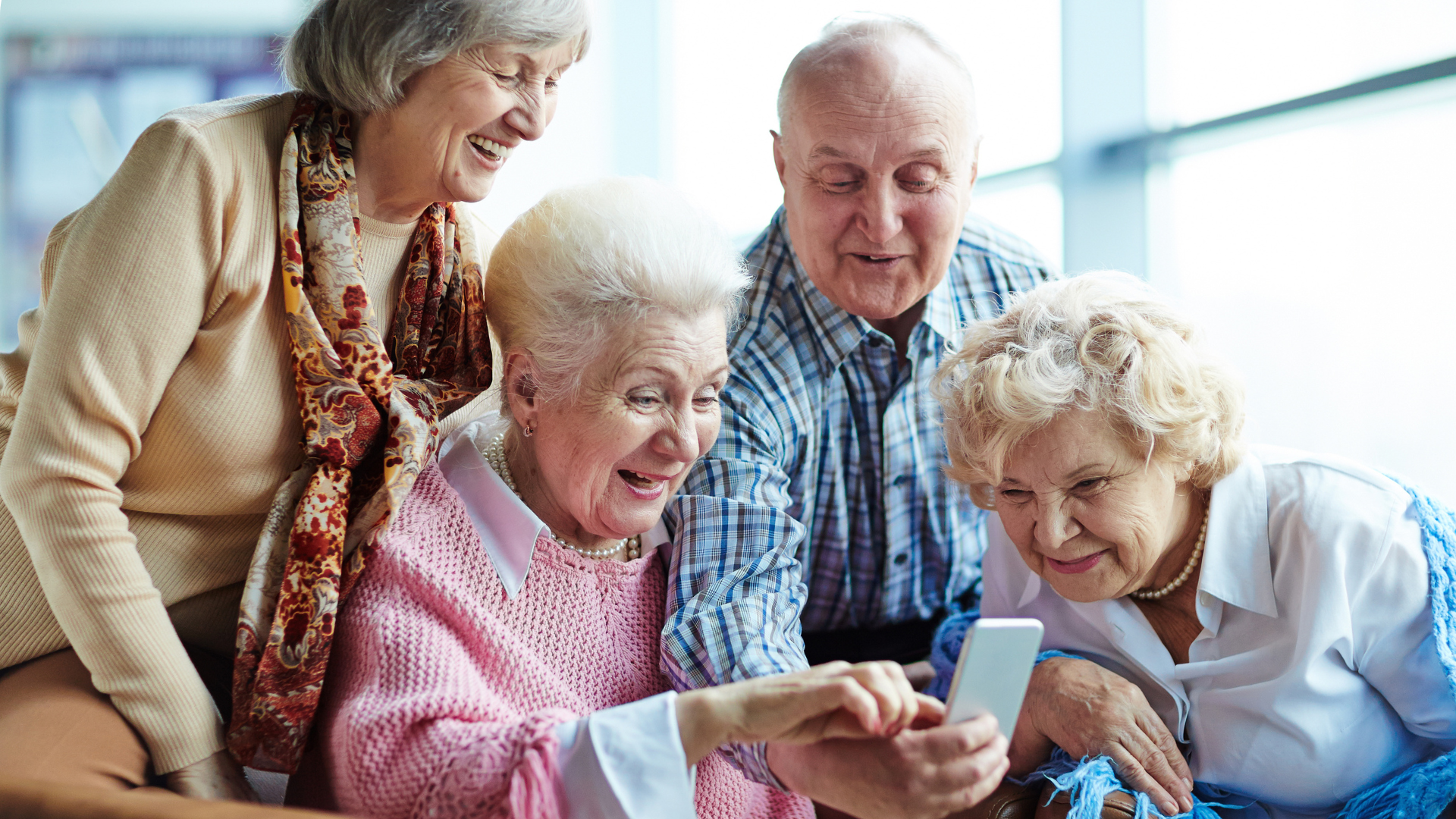 Group of seniors looking at mobile phone 
