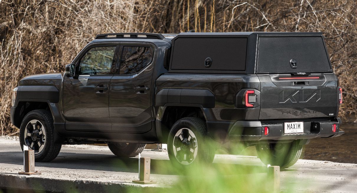 Kia Tasman with MAXIM Canopy on a bridge in nature.