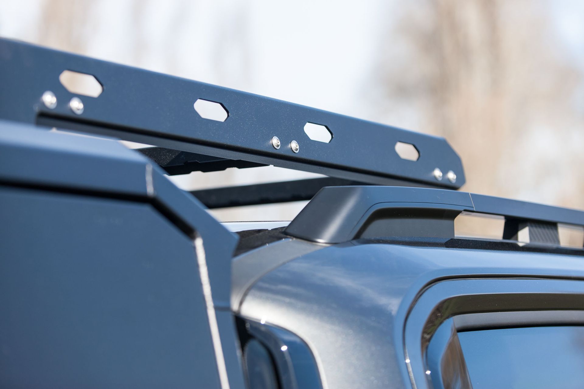 Kia Tasman with MAXIM Hard Lid and MAX tie down rails open on the water.