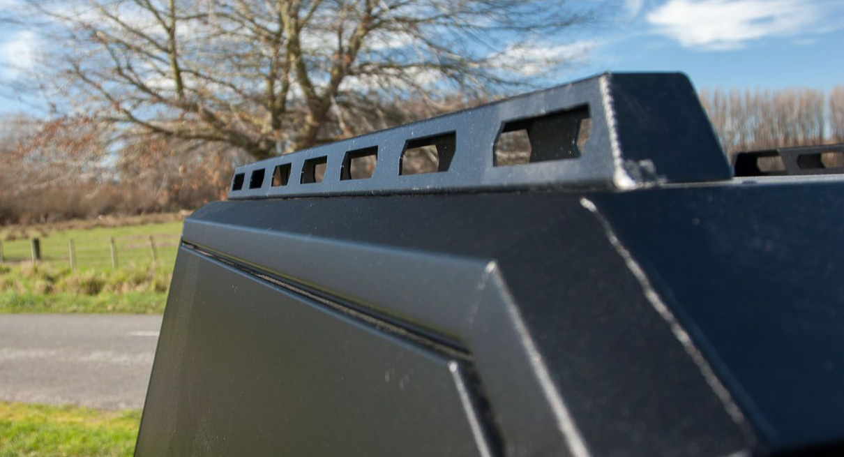 Kia Tasman with MAXIM Canopy on a bridge in nature.